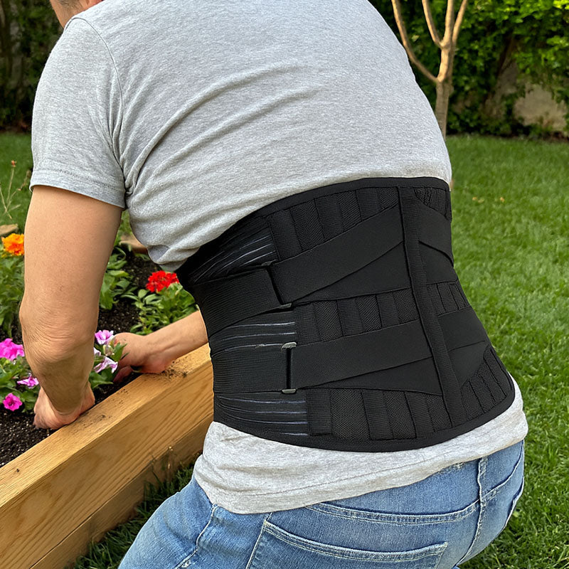 Person wearing a lumbar back brace while gardening
